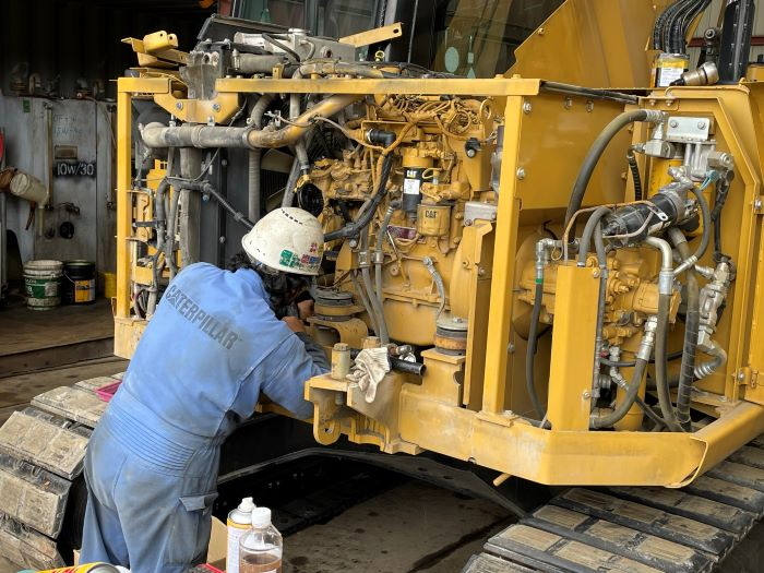 Mechanical fitter working on plant machinery